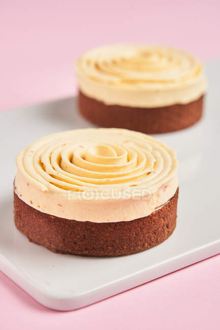 Yummy desserts with cream spiral — Stock Photo