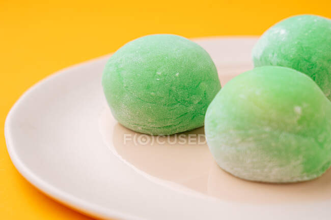 Delicious dessert with green icing — Stock Photo