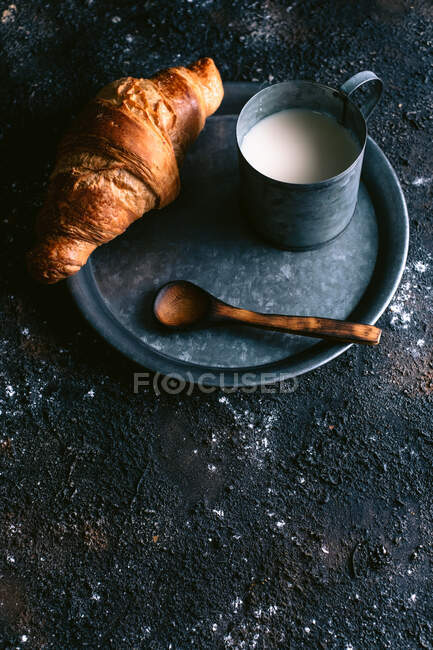 Croissant and milk on table — Stock Photo