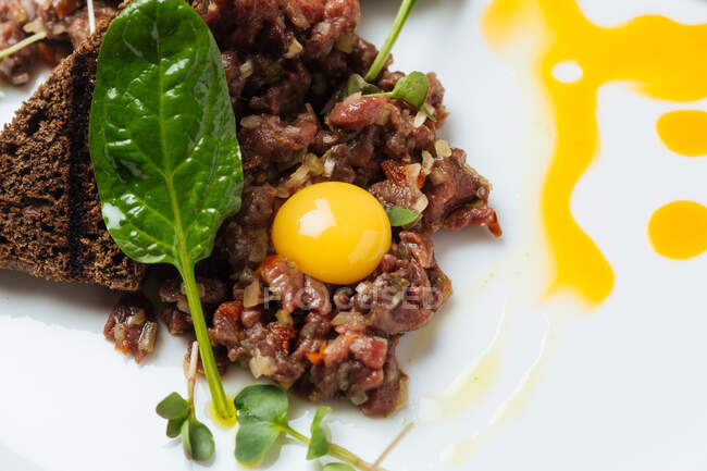 Haute cuisine tartar on white plate — Stock Photo