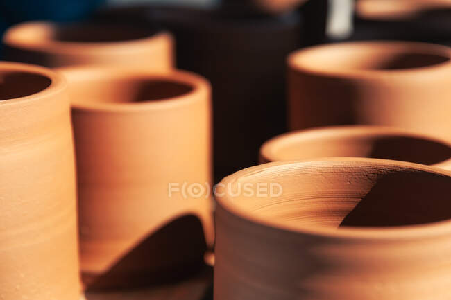 Closeup set of traditional clay pots placed on table in pottery — Stock Photo