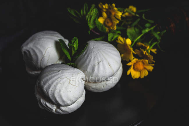 From above homemade white Zefir or Zephyr, Russian traditional dessert with mint on black background — Stock Photo