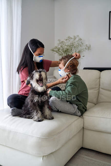 Mother putting on a respirator for her child to avoid possible infection — Stock Photo