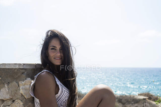 Intimate portrait of young woman posing at the sea. — Stock Photo