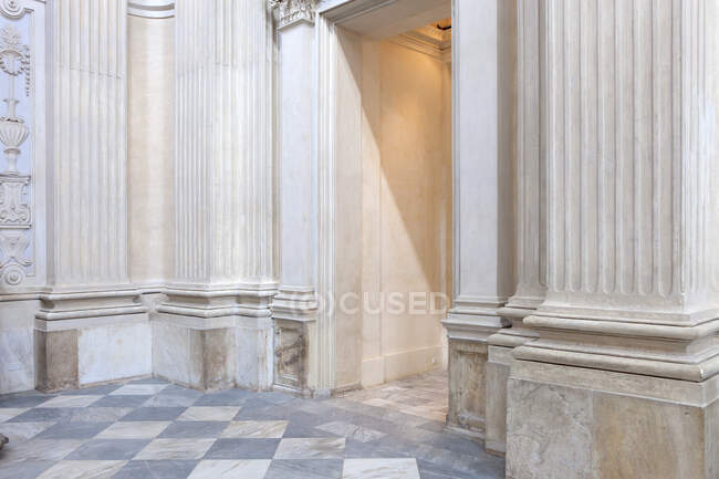 Porte et couloir Shabby à l'intérieur d'un bâtiment vieilli avec des murs en marbre ornemental et un sol carrelé — Photo de stock