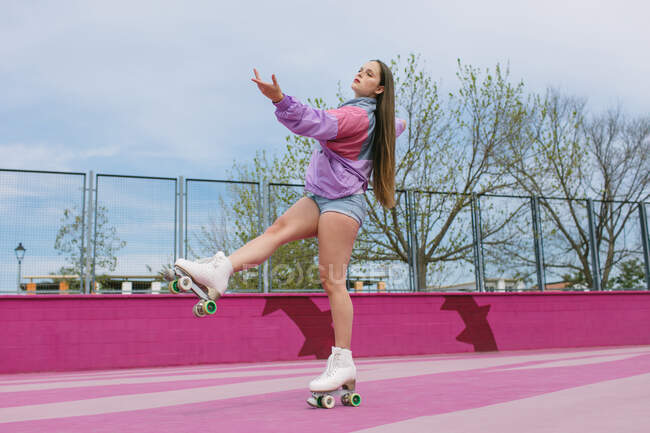 Stylish teenager skating on playground — Stock Photo