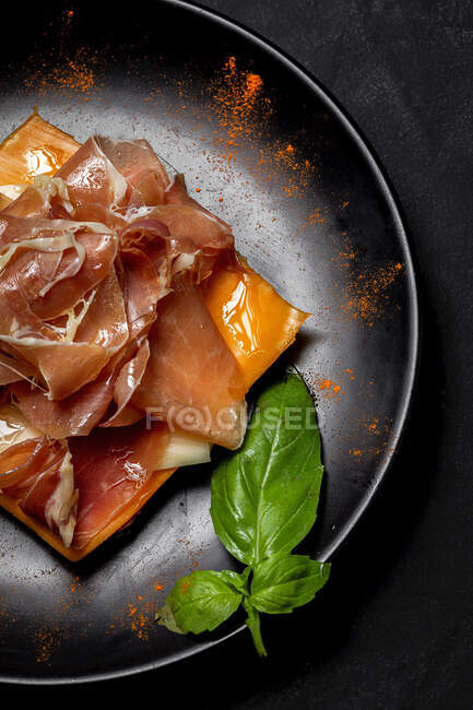 Homemade toasted bread from above with ham and different types of cheeses on dark background — Stock Photo