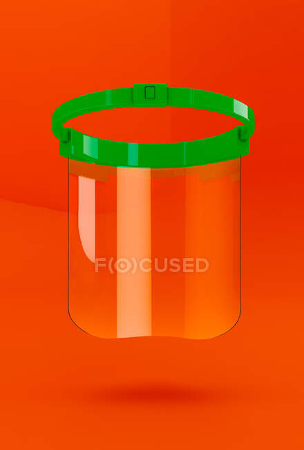Transparente Schutzmaske für die Coronavirus-Pandemie auf orangefarbenem Hintergrund — Stockfoto