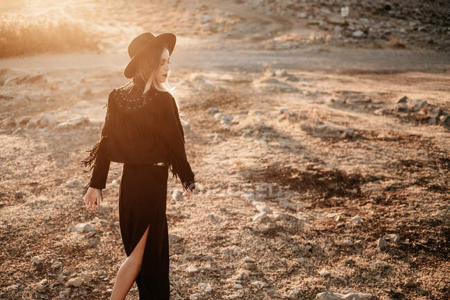 Mulher elegante em pé na rocha no campo — Fotografia de Stock