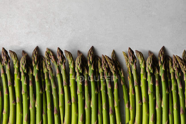 Fresh asparagus on marble table surface — Stock Photo