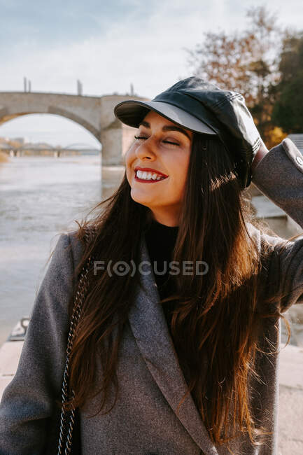 Cheerful young woman on embankment — Stock Photo