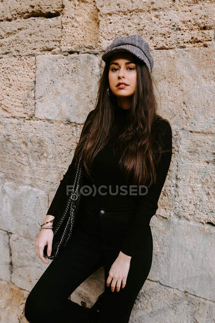 Cheerful young woman near old wall — Stock Photo
