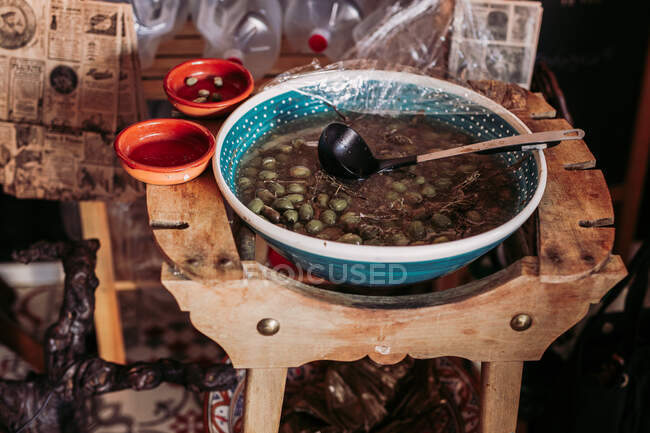 Big bowl of marinated olives while in local delicatessen rustic food store — Stock Photo