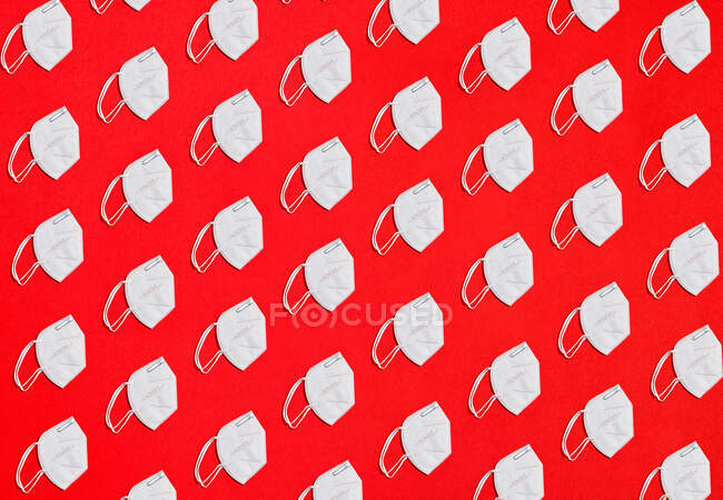 Collage of crowd masks protecting factor KN95 on a red background overhead view — Stock Photo