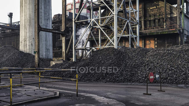 Heaps of coal placed in industrial area at factory for producing coke — Stock Photo