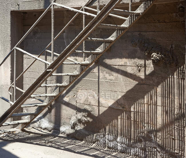 Metal massive staircase with shadow on fabric at daytime — Stock Photo