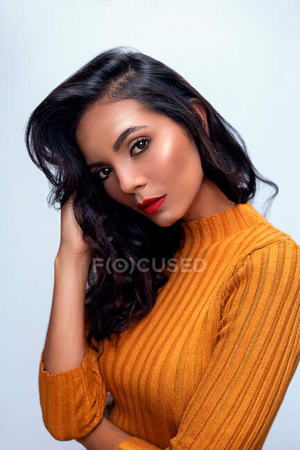 Sensual female model in orange outfit — Stock Photo