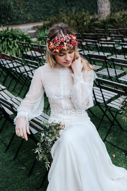 Elegant bride resting on guest seats — Stock Photo
