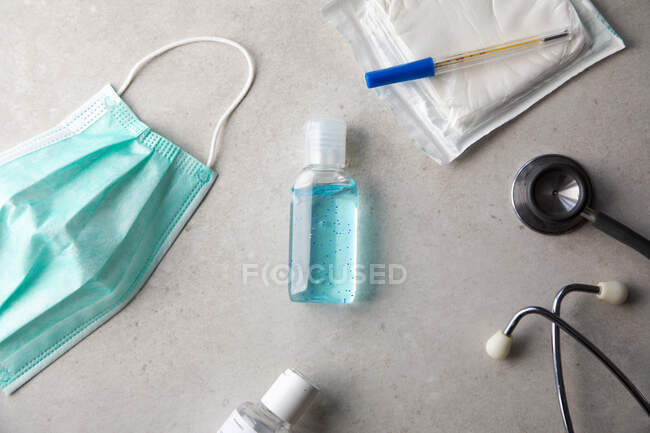 Antibacterial gel, medical mask and stethoscope on table — Stock Photo