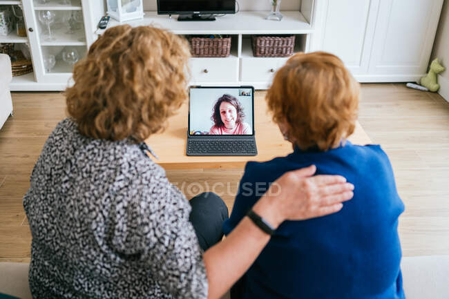 Women having video conversation on laptop at home — Stock Photo
