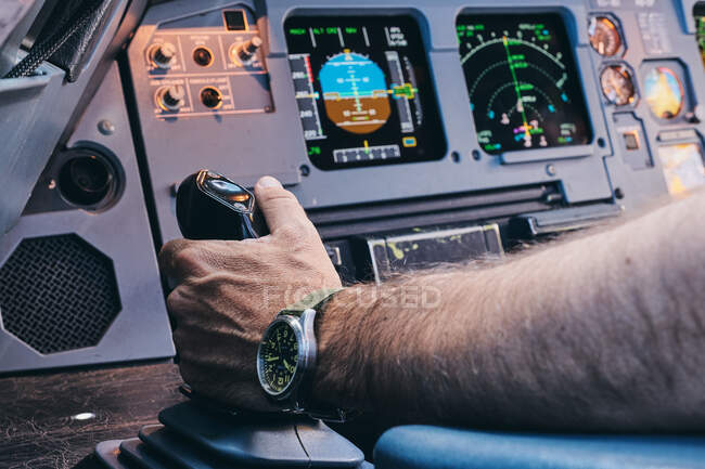 Crop anonymous male pilot performing manual control of contemporary aircraft during flight — Stock Photo