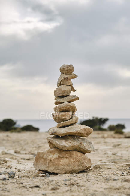 Stones stacked on each other on sandy ground — Stock Photo