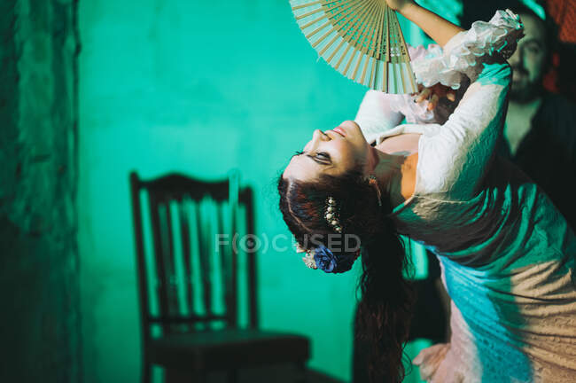 Serious Hispanic flamenco dancer with waver acting on stage — Stock Photo