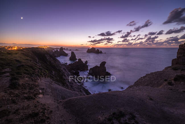 Мальовнича сцена морського узбережжя зі скелями і красивим небом заходу сонця — стокове фото