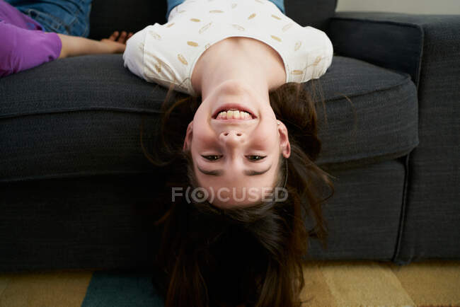 Happy siblings having fun together on sofa at home — Stock Photo