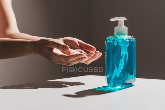 Flow of blue liquid soap coming out of dispenser — Stock Photo