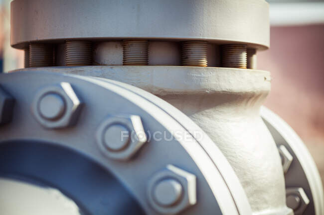 Rusty flanged joints of pipe bolting together with metal nuts at plant — Stock Photo