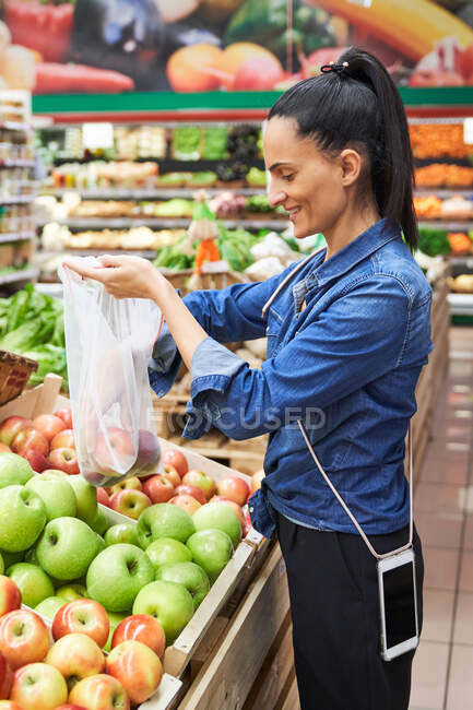 Ragazza che acquista frutta e verdura utilizzando sacchetti riciclabili — Foto stock