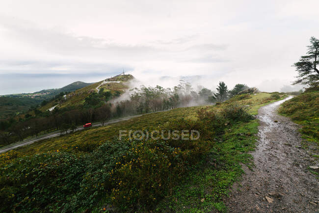 View of green hills with low clouds — Stock Photo