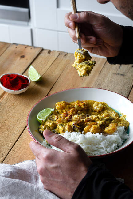 Cropped shot of man with portion of prawn curry with rice — Stock Photo