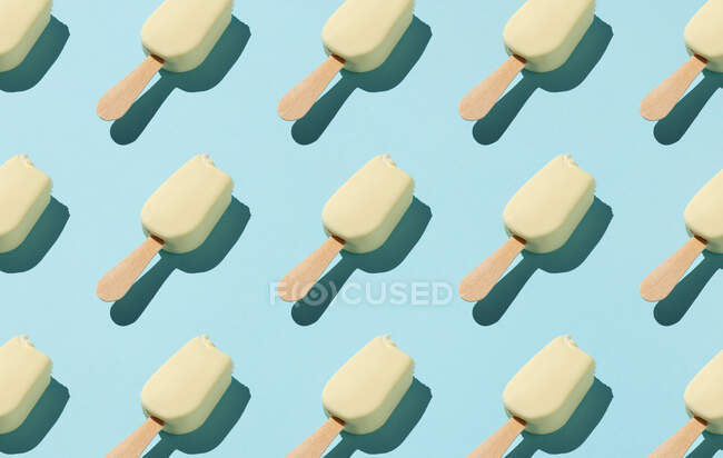Бесшовный рисунок съеденного мороженого на синем фоне — стоковое фото