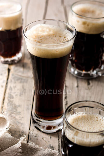 Traditional kvass beer mugs on wooden table — Stock Photo