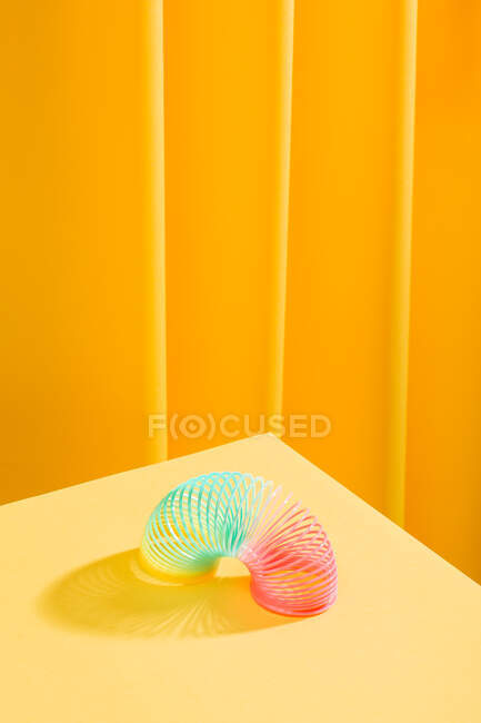 Abstrakte Komposition eines bunten Spielzeugs über einem gelben Tisch — Stockfoto