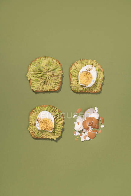 Top view of avocado toasts with boiled eggs for breakfast — Stock Photo