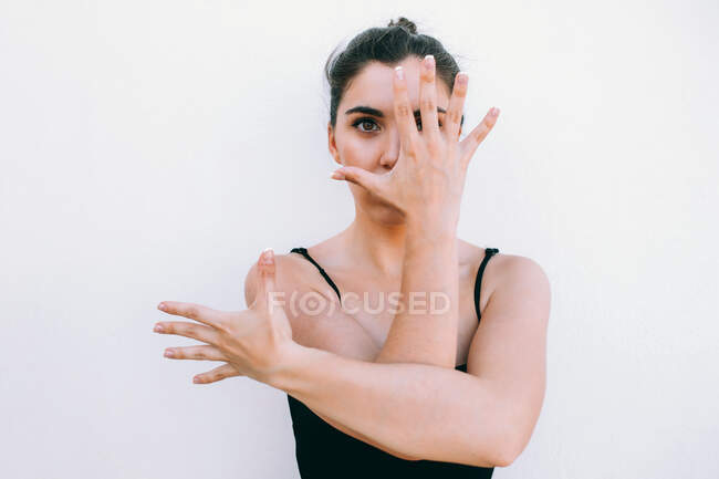 Tranquil female dancer performing looking at camera on street on white background — Stock Photo