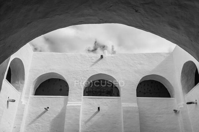 Внешний вид минималистских стен с арками в древнем городе Исамаль против облачного неба — стоковое фото