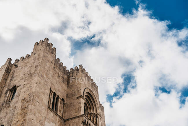 From below of shabby exterior of historic Roman Catholic church located in Portugal on sunny day — Stock Photo