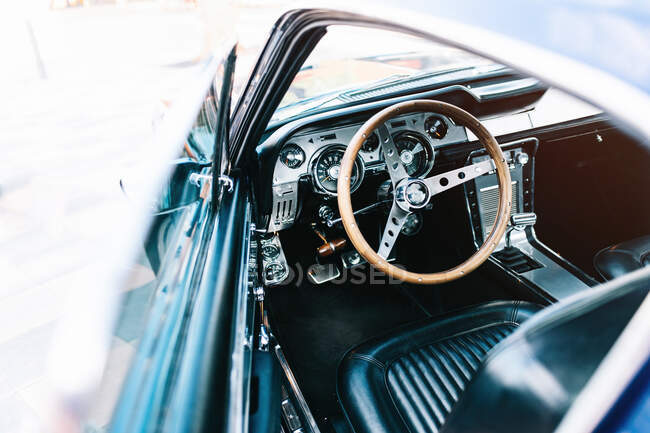 Vintage automobile with wooden steering wheel and leather seat — Stock Photo