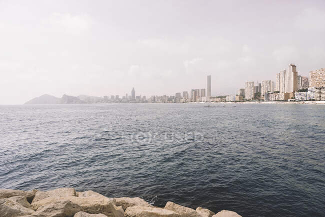 Skyline of Benidorm city with contemporary architecture seen from waterfront of sea — Stock Photo