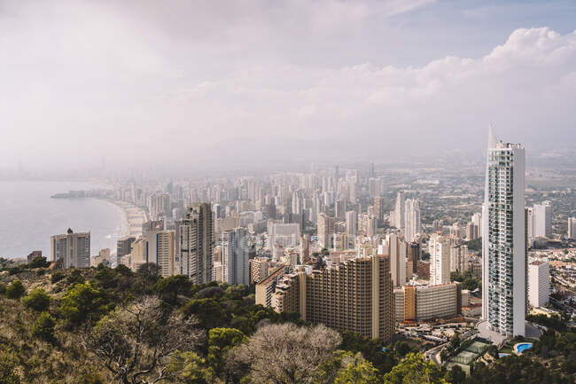 Cityscape of densely built Benidorm city district with contemporary skyscrapers covered with haze in Spain — Stock Photo