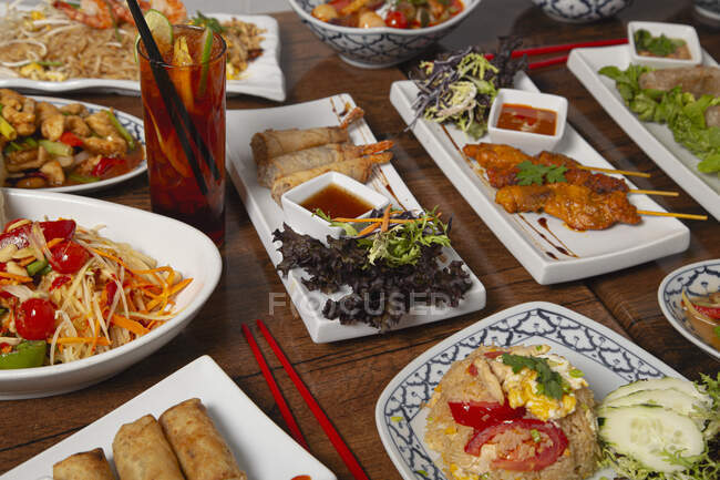 Assortiti cibo speziato tailandese servito su tavolo di legno — Foto stock