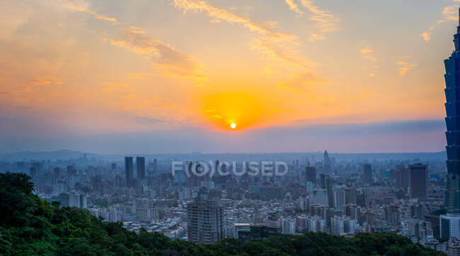 Magnificent panoramic view of sunset with colorful cloudy sky over modern city with skyscrapers in summer evening in Taiwan — Stock Photo