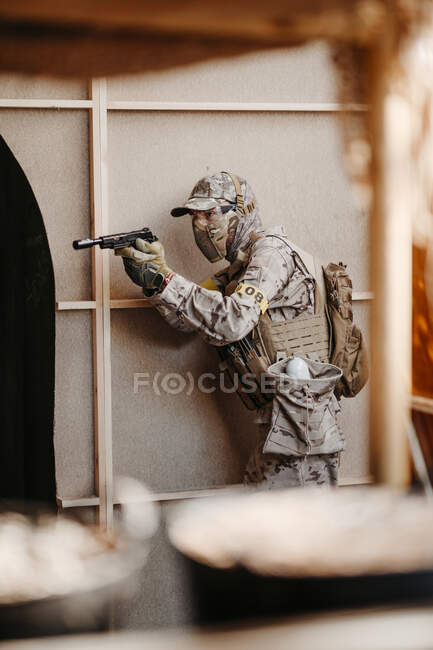 Soldier aiming airsoft gun during tactical game — Stock Photo