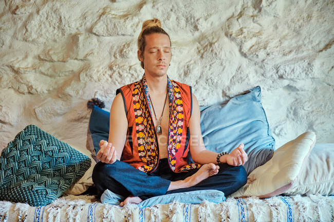 Homme blond pratiquant la méditation avec les yeux fermés à la maison — Photo de stock