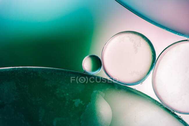 Closeup of abstract background with round shaped cells of vaccine of different sizes illuminated by colorful light — Stock Photo