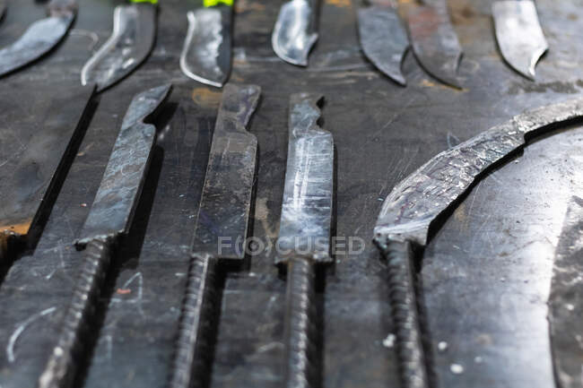 From above of rows of various metal instruments placed on table in smithy — Stock Photo